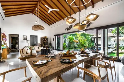 a dining room with a large wooden table and chairs at Villa Jami by BaliSuperHost in Seminyak
