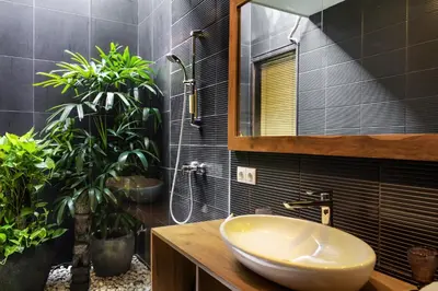 a bathroom with a sink and a mirror and plants at Villa Jami by BaliSuperHost in Seminyak