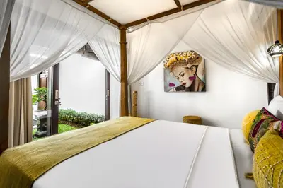 a bedroom with a bed and a window at Villa Jami by BaliSuperHost in Seminyak