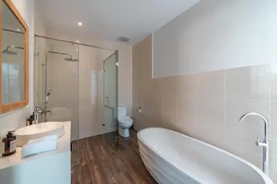a bathroom with a tub and a sink and a toilet at Villa Selikur 2 - Brand New! Spacious 3BR Villa in Seminyak in Seminyak