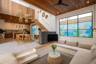 a living room with a couch and a fireplace at Villa Solaris Umalas by Santi Management in Kerobokan