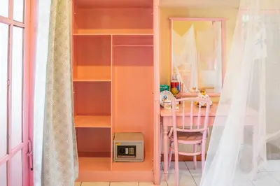 a room with a table and a pink shelf at BS Home in Kuta