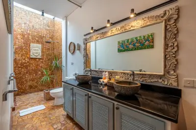 a bathroom with two sinks and a large mirror at Villa Vaiana Seminyak in Seminyak