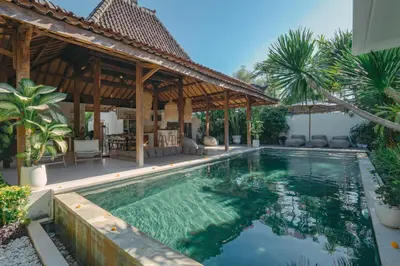 a swimming pool in front of a villa at Villa Marula at Bidadari in Seminyak