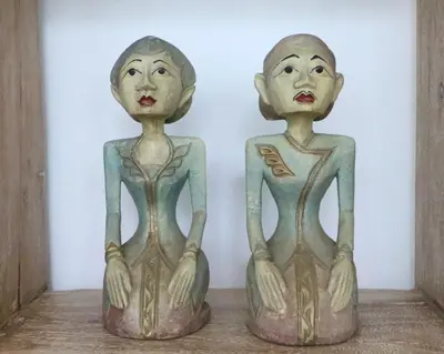 two wooden dolls sitting on a shelf at Stylish Three Bedroom Villa Near Atlas Beach Club & Beach. in Canggu