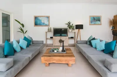 a living room with a couch and a coffee table at Stylish Three Bedroom Villa Near Atlas Beach Club & Beach. in Canggu