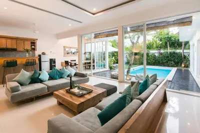 a living room with a couch and a table at Stylish Three Bedroom Villa Near Atlas Beach Club & Beach. in Canggu