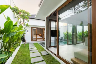 an external view of a house with a garden at J4 Villas Sanur in Sanur