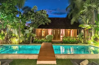 a swimming pool in front of a villa at Villa Joglo Oberoi Seminyak Beautiful 4BR Villa Prime Location in Seminyak