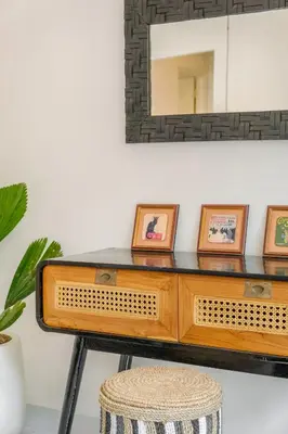 a dressing table with a mirror and a stool at Villa Marina Seminyak in Seminyak