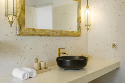 a bathroom sink with a black bowl and a mirror at Villa Marina Seminyak in Seminyak