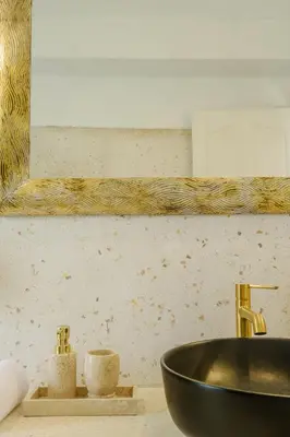 a bathroom with a black sink and a mirror at Villa Marina Seminyak in Seminyak