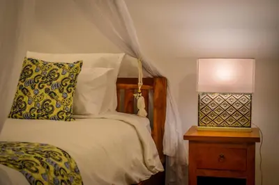 a bedroom with a bed and a lamp on a nightstand at Villa Mana Tea 2 bedrooms & pool Seminyak in Seminyak
