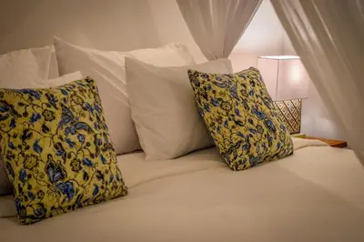 a bed with two pillows on it with at Villa Mana Tea 2 bedrooms & pool Seminyak in Seminyak