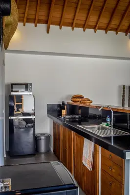 a kitchen with a sink and a stove top oven at Villa Mana Tea 2 bedrooms & pool Seminyak in Seminyak