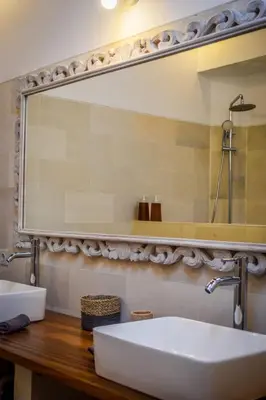 a bathroom with a large mirror and a sink at Villa Mana Tea 2 bedrooms & pool Seminyak in Seminyak