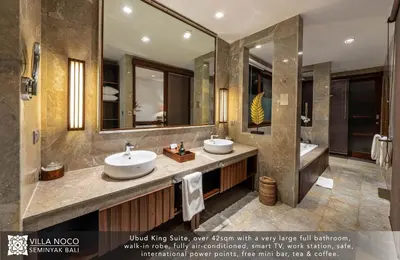 a bathroom with two sinks and a large mirror at Noco Luxury Villa Seminyak in Seminyak
