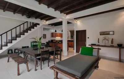 a dining room and kitchen with a table and chairs at Nativ Living Villa Legian 6BR Villa 16px Big Group Walk to 66 Beach in Seminyak