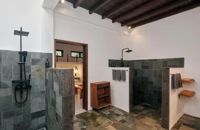 a bathroom with a shower and a walk in shower stall at Nativ Living Villa Legian 6BR Villa 16px Big Group Walk to 66 Beach in Seminyak