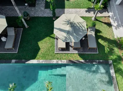 an overhead view of a pool with a table and umbrella at Nativ Living Villa Legian 6BR Villa 16px Big Group Walk to 66 Beach in Seminyak