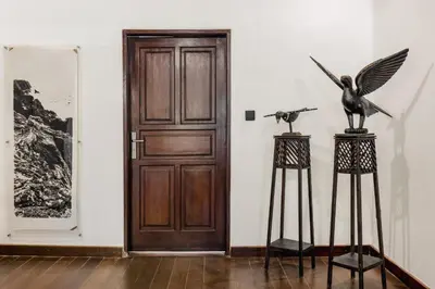 a door in a room with a statue of a bird at Nativ Living Villa Legian 6BR Villa 16px Big Group Walk to 66 Beach in Seminyak