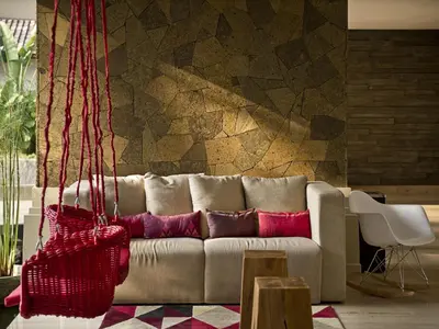 a living room with a couch with red pillows at Grand Zuri Kuta Bali in Kuta