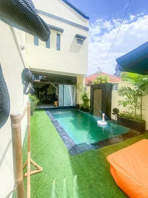 a swimming pool in the backyard of a house at Villa Coco Legian in Legian