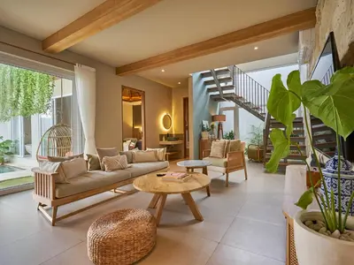 a living room with a couch and a table at Luna Ola Villa Berawa in Canggu