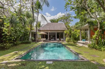 a swimming pool in front of a house at Eshara 3 our Peaceful 3BR Pool Villa close to Oberoi Beach in Seminyak