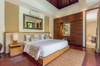 a bedroom with a large bed and a mirror at Eshara 21 our Luxury 5BR Villa Escape and huge pool Oberoi Beach in Seminyak