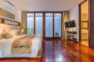 a bedroom with a large bed and a television at Eshara 21 our Luxury 5BR Villa Escape and huge pool Oberoi Beach in Seminyak