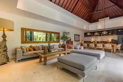 a living room with two couches and a table at Eshara 23 an Amazing 5 BR Pool Villa walking distance to Beach in Seminyak