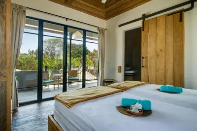 a bedroom with a bed and a large window at Villa Lio - Tropical Escape in Canggu in Canggu