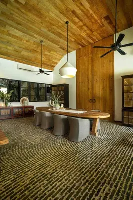 a dining room with a wooden table and chairs at Villa Lio - Tropical Escape in Canggu in Canggu
