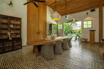 a large dining room with a wooden table and chairs at Villa Lio - Tropical Escape in Canggu in Canggu
