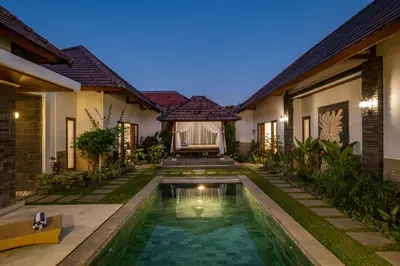 an image of a villa with a swimming pool at night at Villa Lapiz in Seminyak