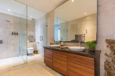 a bathroom with two sinks and a shower at Eshara 123 in Oberoi our 8 BR Villa with 3 Pool close to Beach in Seminyak