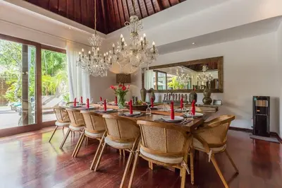 a dining room with a long table and chairs at Eshara 123 in Oberoi our 8 BR Villa with 3 Pool close to Beach in Seminyak
