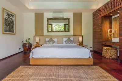 a bedroom with a large bed and a mirror at Eshara 123 in Oberoi our 8 BR Villa with 3 Pool close to Beach in Seminyak