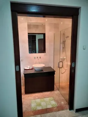 a bathroom with a sink and a shower at Villa Layang Bulan a homey guesthouse for men near the beach in North Kuta in Denpasar