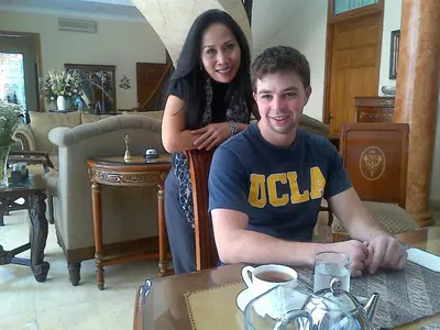 a man and a woman sitting at a table at Guildwood Villa Bali in Sanur