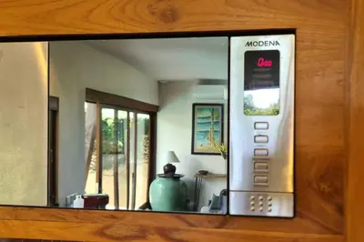 a mirror reflection of a remote control in a room at Jado 1 Unique Cinema Entertainment Villa in Umalas in Kerobokan