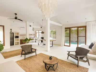 an open living room with a chandelier at Stylish 2bdr poolvilla Centre Seminyak in Seminyak