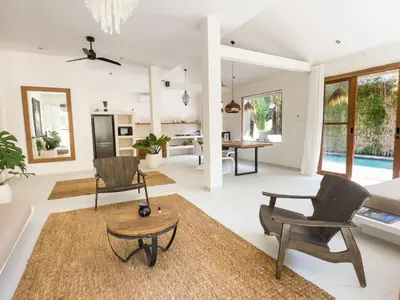 a living room with chairs and a table at Stylish 2bdr poolvilla Centre Seminyak in Seminyak