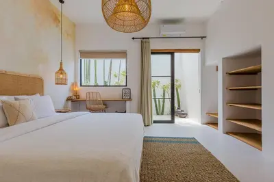 a bedroom with a large white bed and a desk at Villa Kiara our Paradise in Seminyak 5 bedrooms 12m private pool in Seminyak