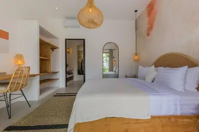 a bedroom with a large bed and a desk at Villa Kiara our Paradise in Seminyak 5 bedrooms 12m private pool in Seminyak