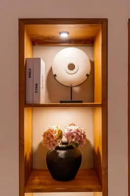 a wooden shelf with a vase with flowers in it at An Amazing 6BDR Private Family Villa with Pool in Tanah Lot