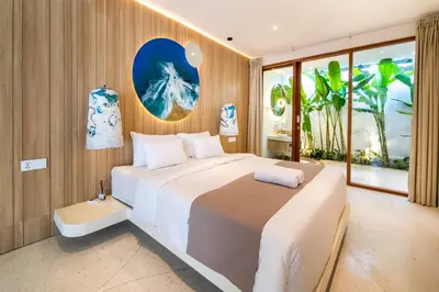 a bedroom with a large bed and a large window at Magic Mango Villa Huge Projector bubble bath unique design in Canggu
