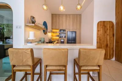 a kitchen with two chairs and a counter top at Magic Mango Villa Huge Projector bubble bath unique design in Canggu