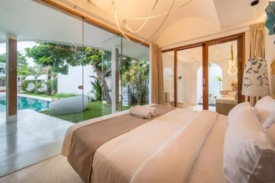 a bedroom with a large bed and a pool at Magic Mango Villa Huge Projector bubble bath unique design in Canggu